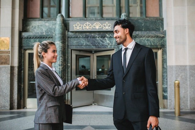woman in business shaking hands with customer